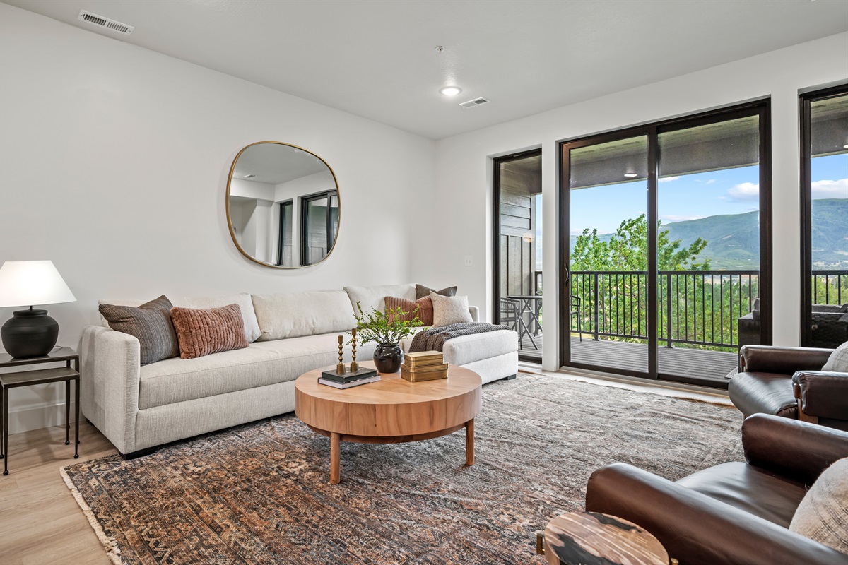 Enjoy natural light, fresh mountain air, and direct access to the deck from this inviting living space.