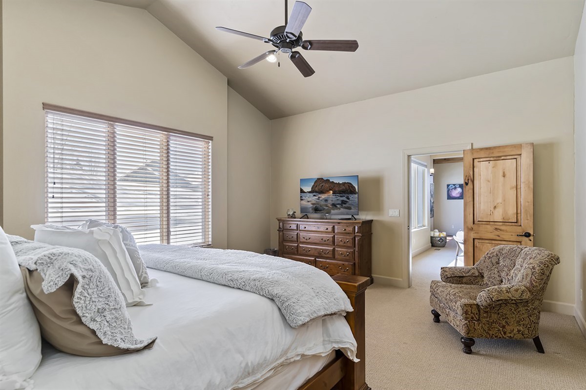 A cozy bedroom retreat with warm finishes and plenty of natural light.