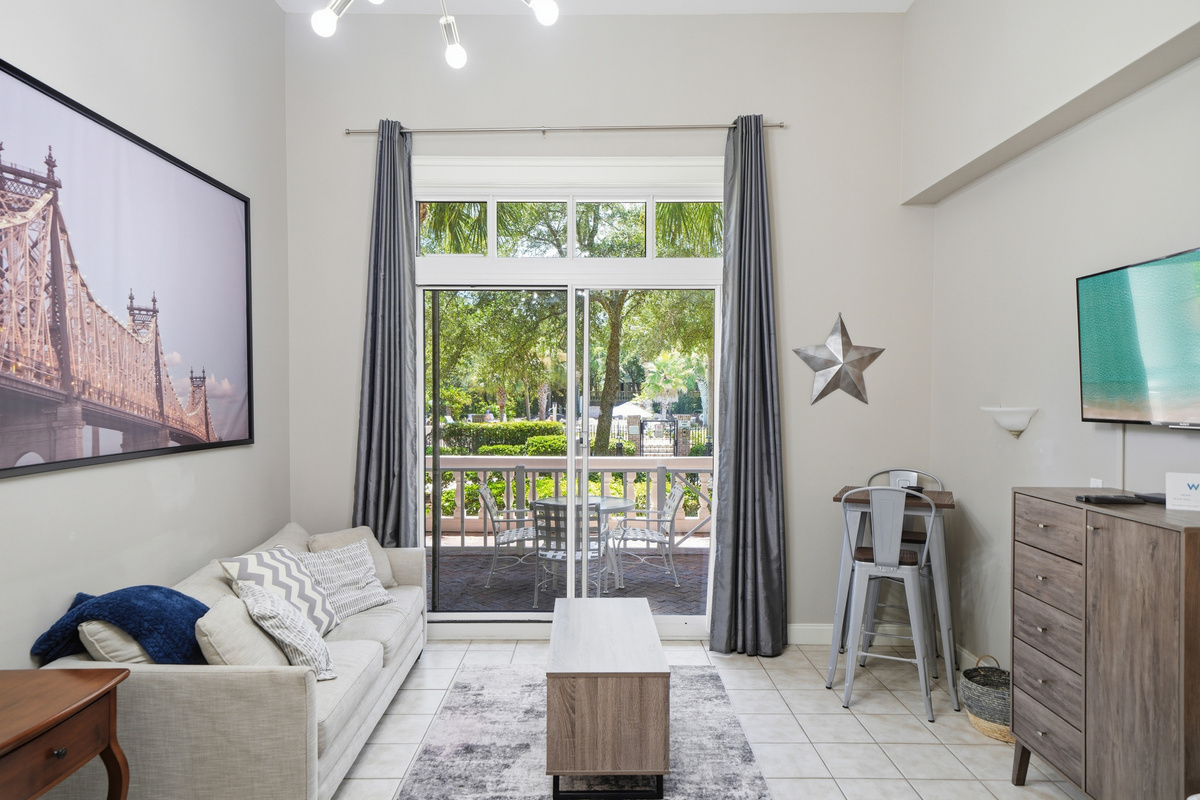 Ground-floor fenced in patio area with seating for four.