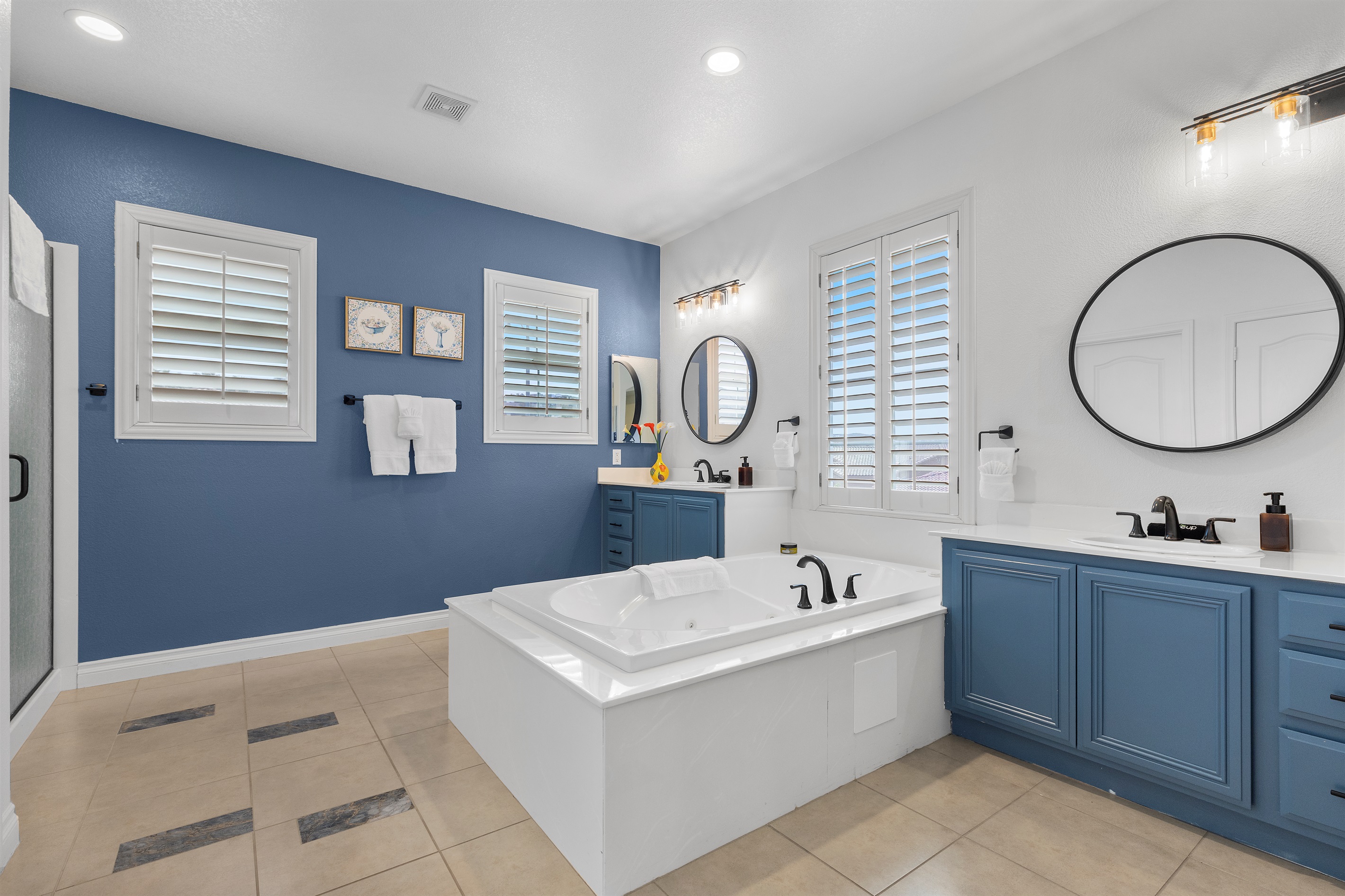 En-suite Master bathroom with dual sinks, a soaking tub, and a separate stand-up shower.  It's Showtime!