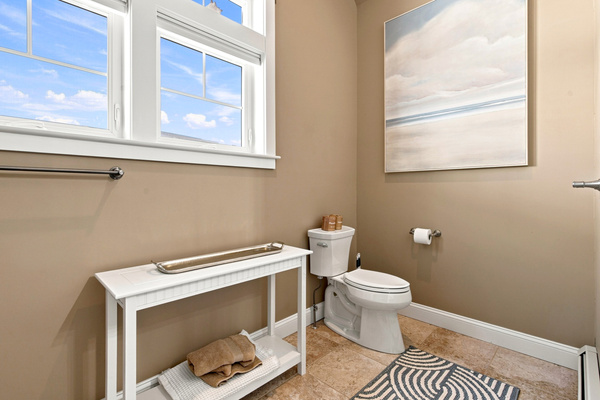 A bright and convenient bathroom with natural light and thoughtful space for everyday essentials.
