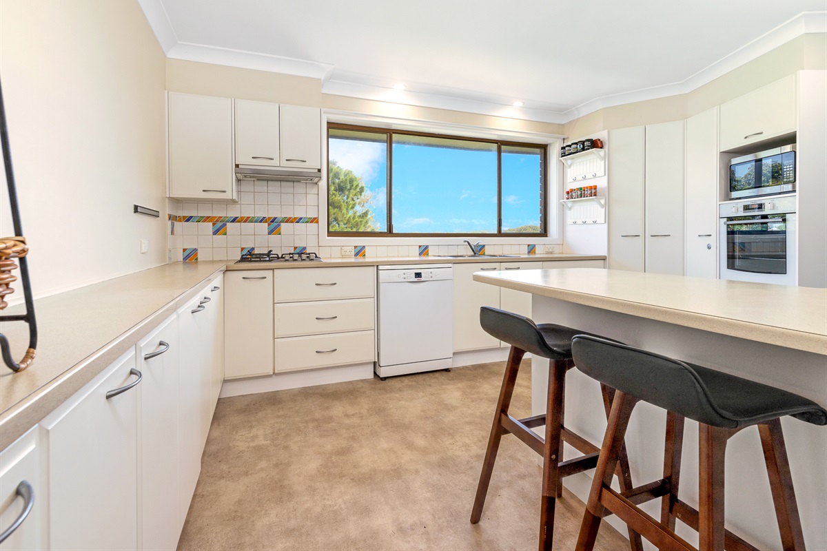 This kitchen angle shows the scale of the cooking space, with room to prepare meals without crowding the main upstairs living area