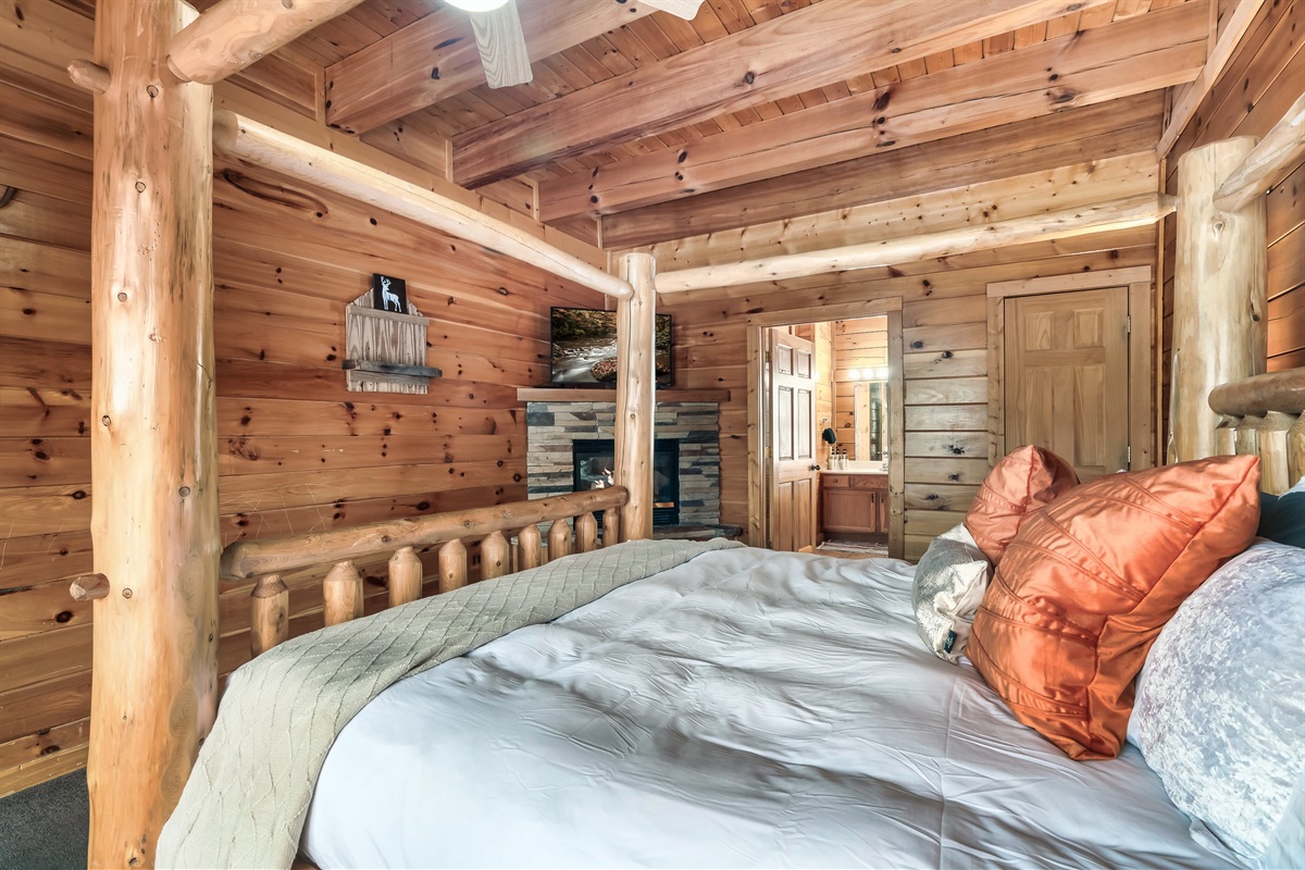 Relax in a main level king suite with a cozy fireplace, private jacuzzi bath, and easy access for restful nights.