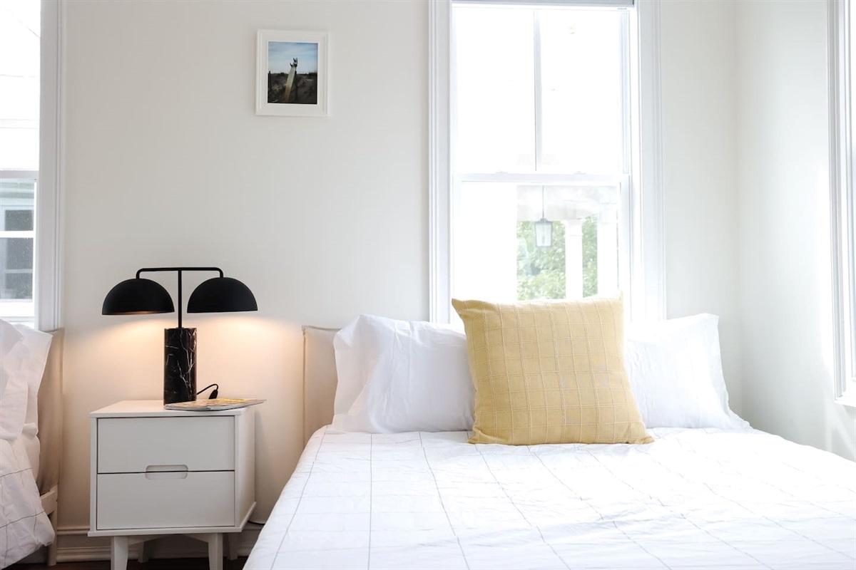 The spacious "sunrider room" features two queen beds, a spacious double-door closet, a full bath with a shower, smart TV and coastal photography. 