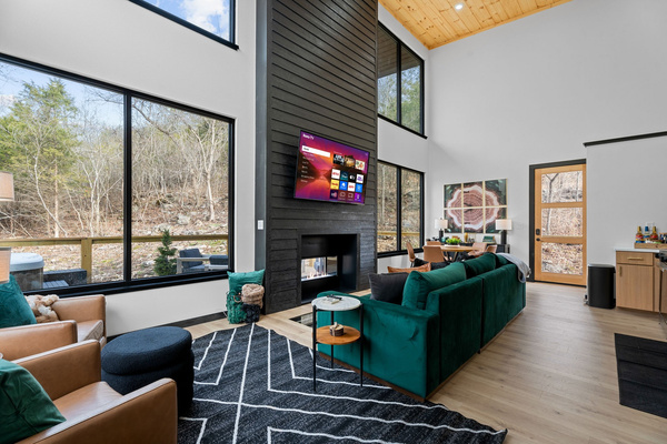 Relax in the bright and airy space living space, featuring plush seating and stunning nature views!