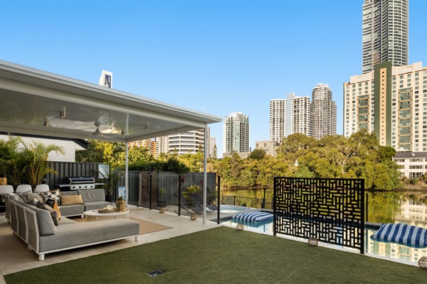 Private waterfront setting with open lawn space and seamless indoor–outdoor flow.