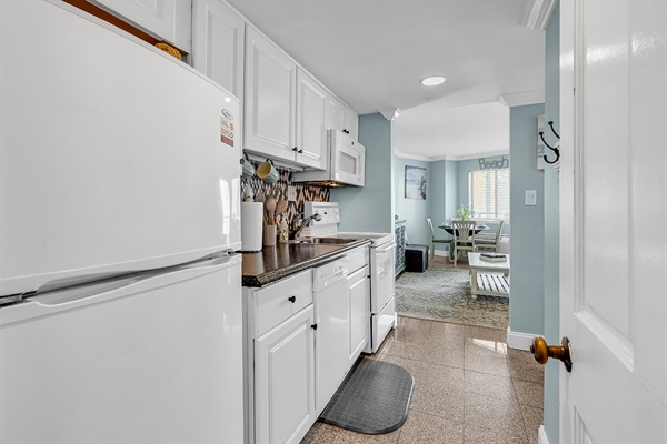 Fully equipped kitchen with full-size refrigerator, stove, microwave, dishwasher, and blender