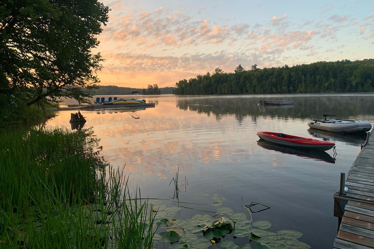 Cottage dock and watercraft in the sunrise early morning