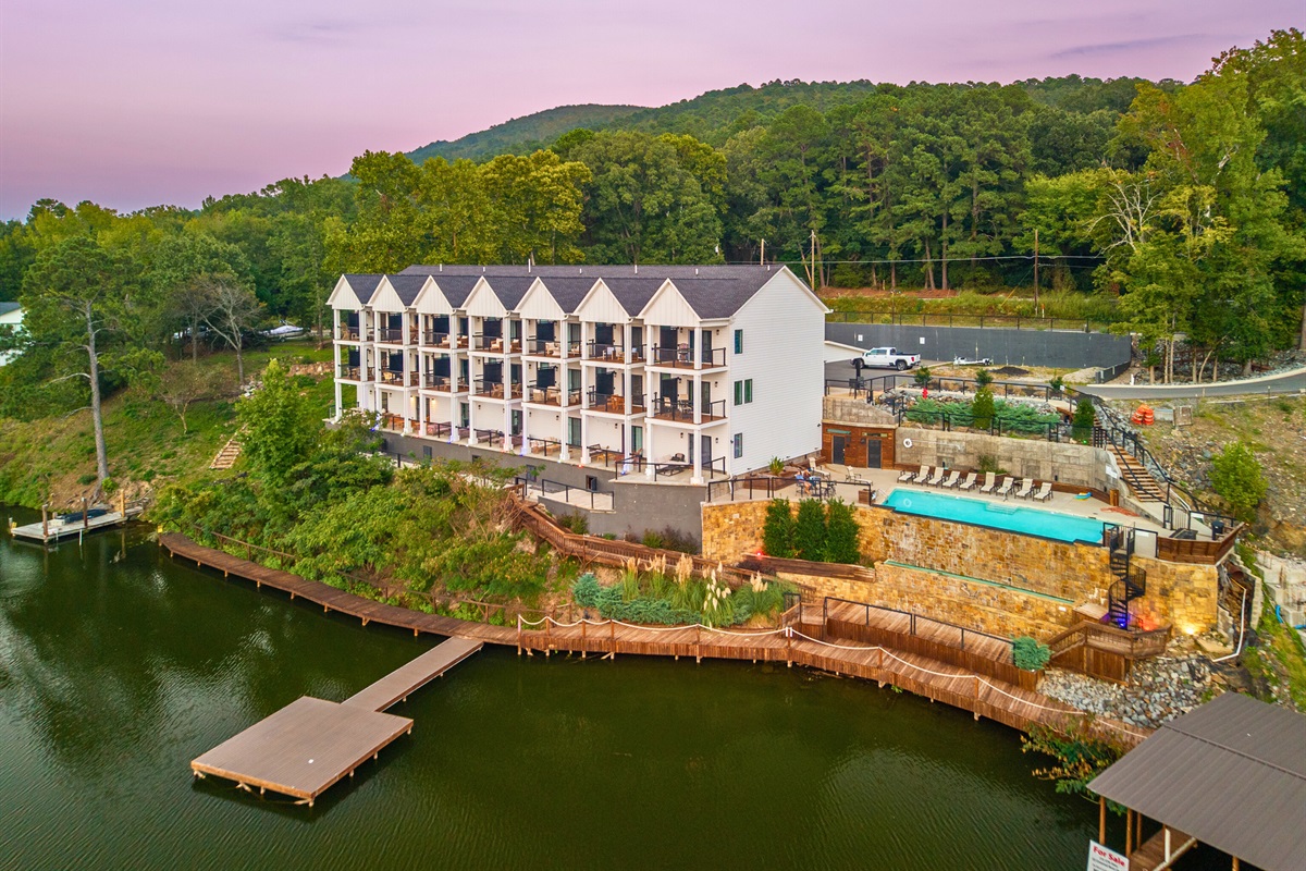 Aerial view &mdash;modern condos with lake views, pool access, and a peaceful setting.