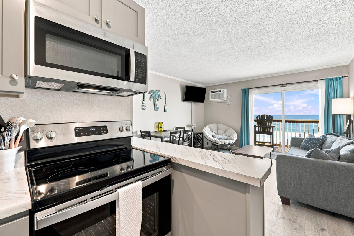 Prepare your favorite dishes while staying connected to the coastal atmosphere with beautiful ocean views just beyond the living area