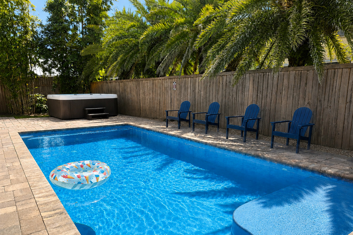 Aqua blue pool that is heated and separate hot tub so it can be enjoyed year-round.