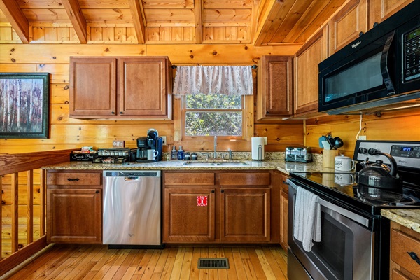 Well-equipped kitchen inside, grill and fire pit outside—meals with a view!