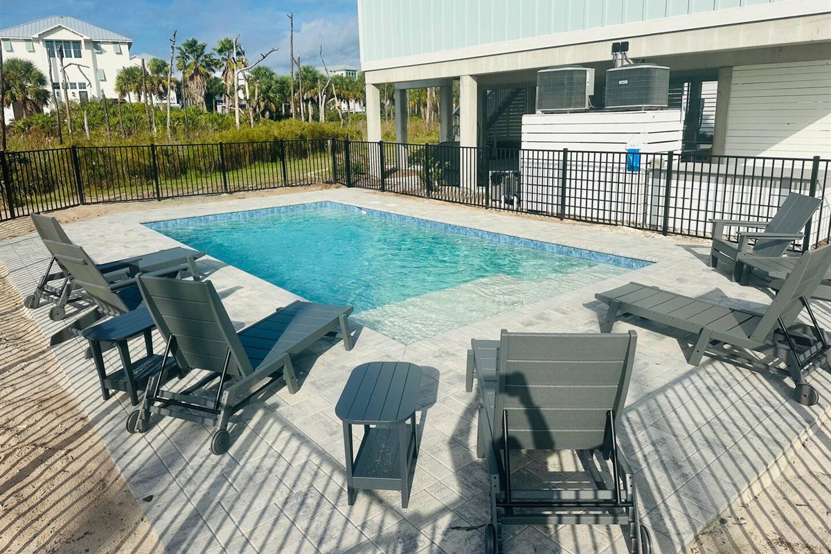 Lounge poolside or cool off in this private 16x20 oasis, featuring a 5-foot deep end and a shallow sun shelf perfect for an umbrella and relaxing in style.