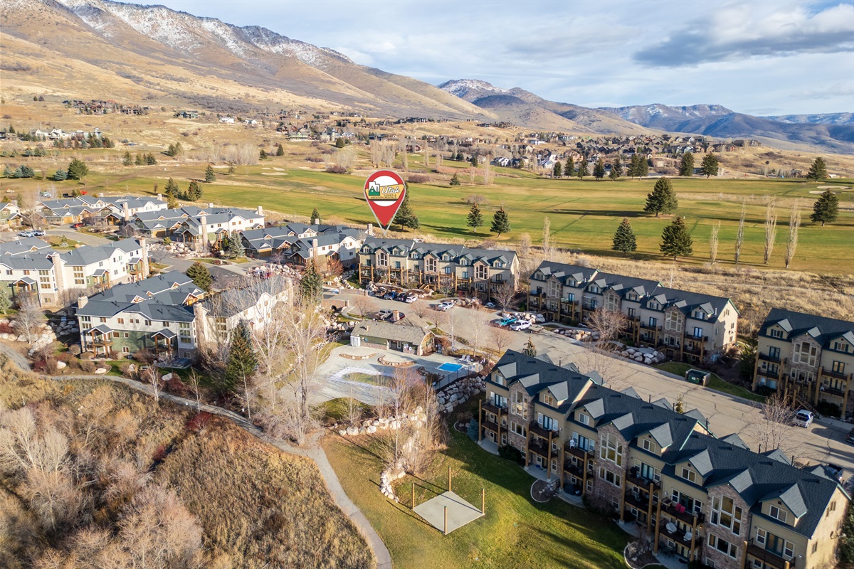 Aerial view of the Moose Hollow community set against sweeping valley and mountain scenery.