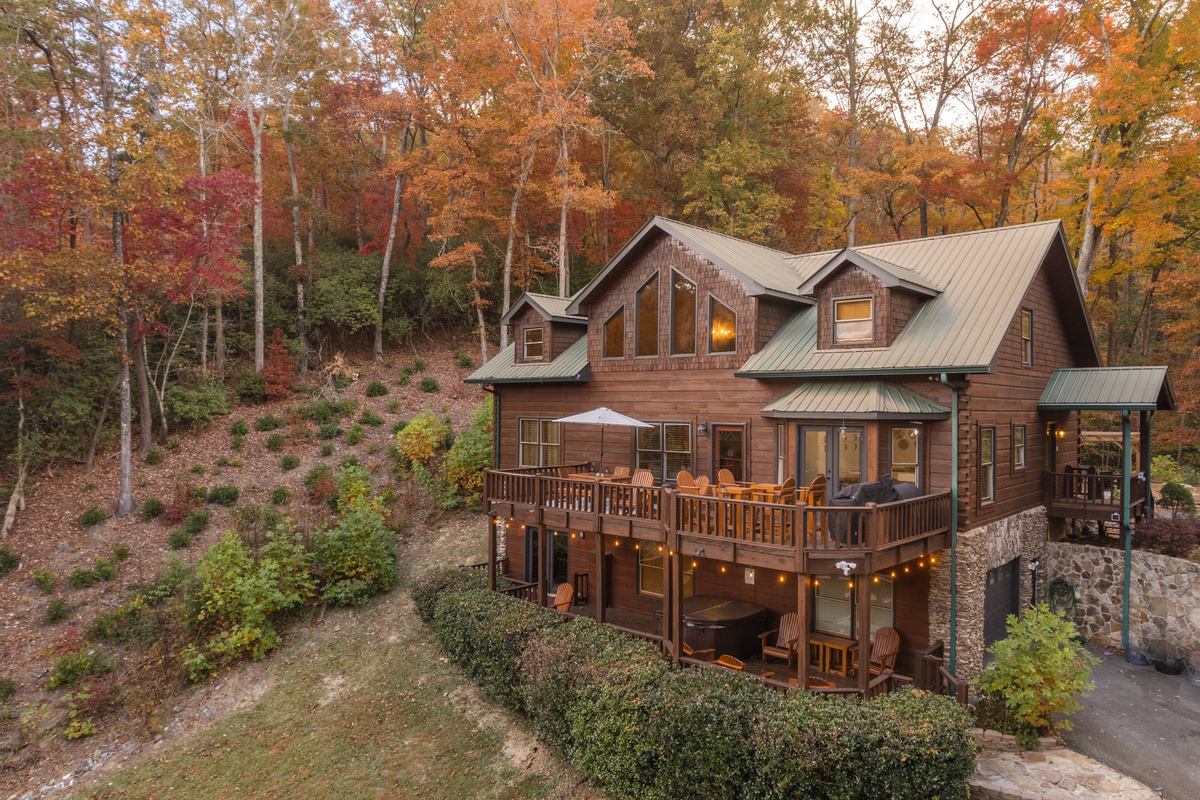Large cabin surrounded by fall foliage