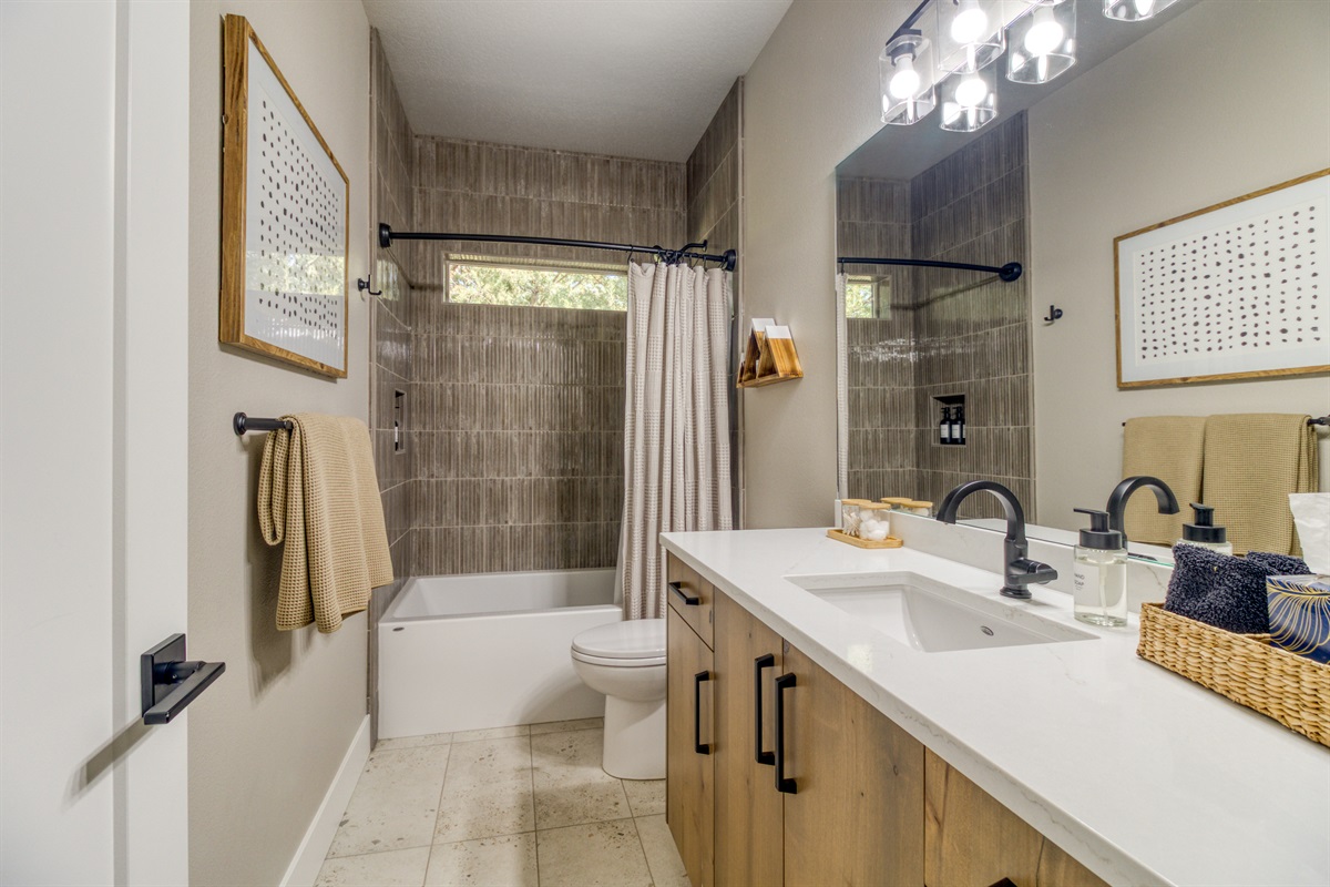 Downstairs bath #2 services King Bedroom #3 and the Bunk Room.  Tile tub/shower.