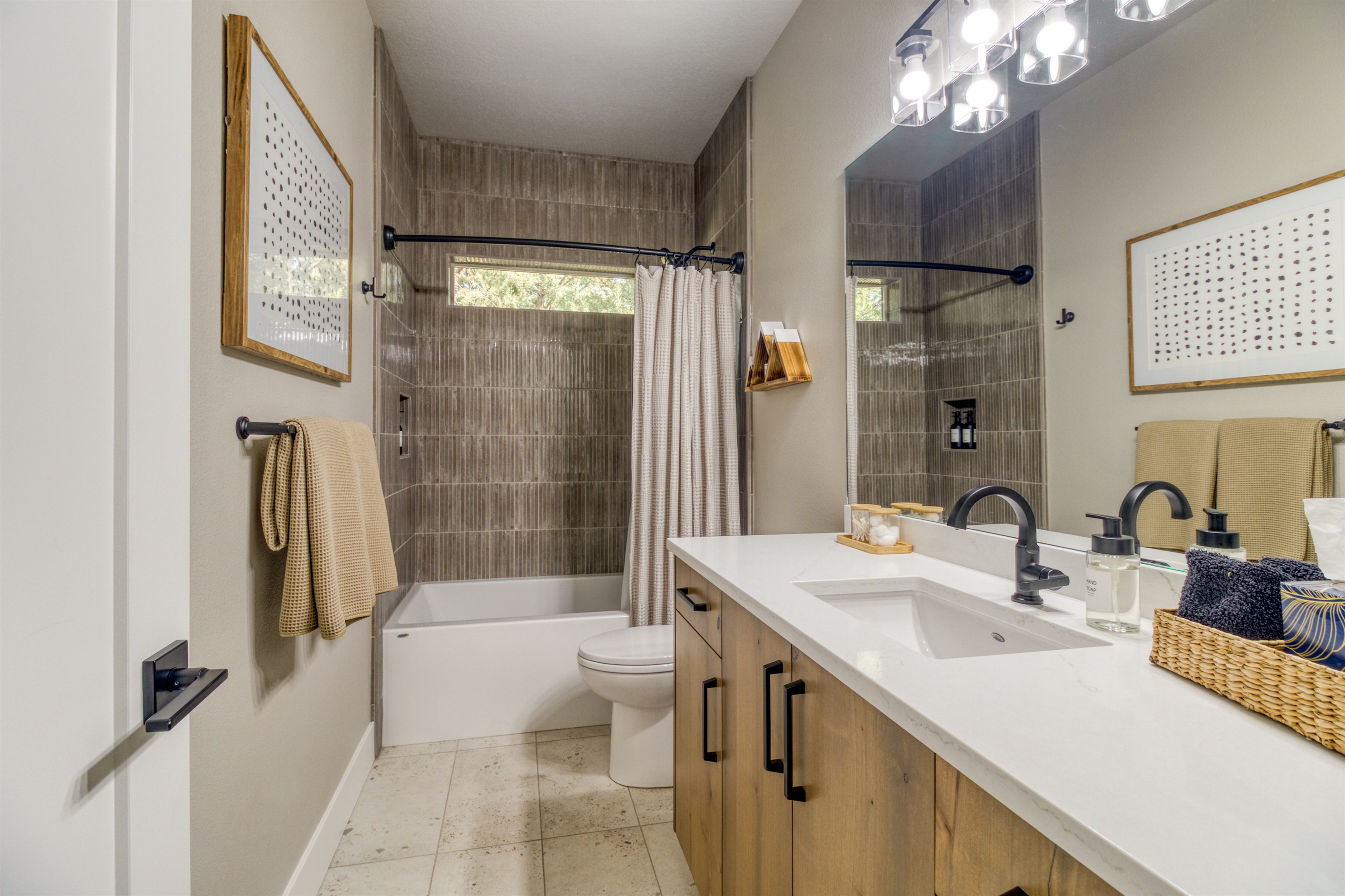 Downstairs bath #2 services King Bedroom #3 and the Bunk Room.  Tile tub/shower.