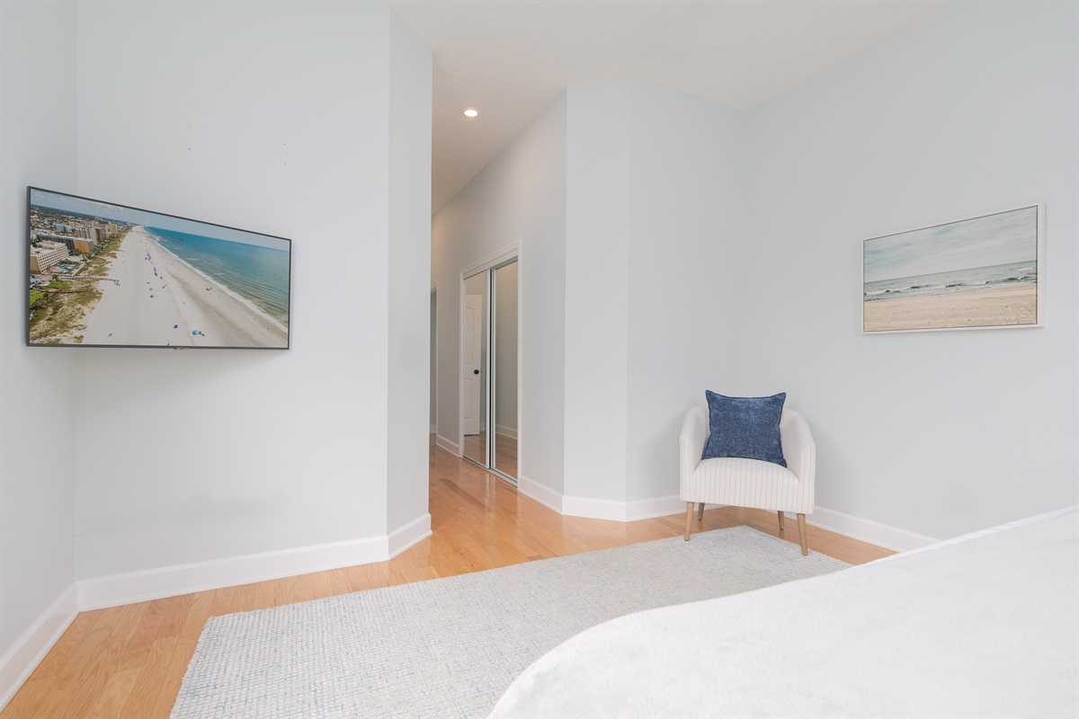 Primary bedroom with Smart TV and sitting area
