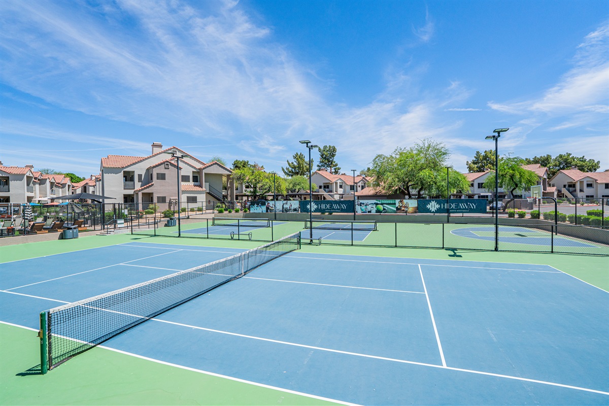 Enjoy a match on this wide-open tennis court, perfect for a sunny day!