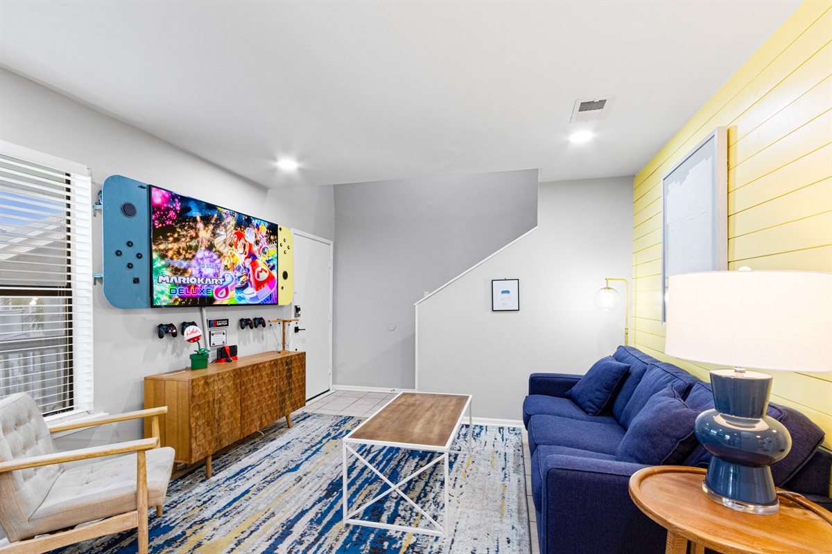 [Living room] 65" Smart TV where you can log into your Apple TV, Disney+, HBO Max, Hulu, Netflix & Roku, etc.