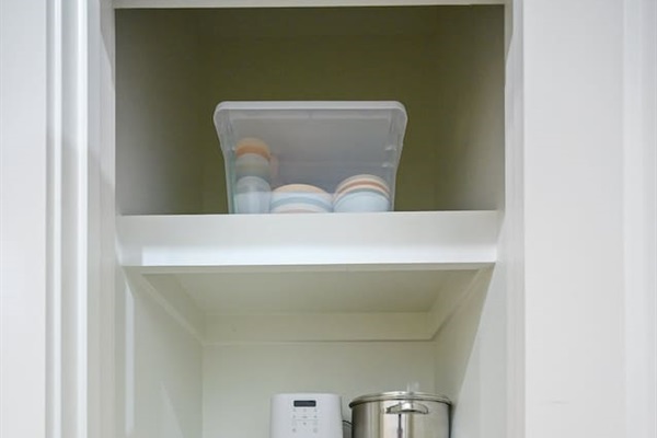 In our pantry you will find some things for the littles...kid's dishes, Bumbo seat & Booster Feeding Chair. We also keep a large soup pot, Bella air fryer and our crockpot which is not pictured here. 