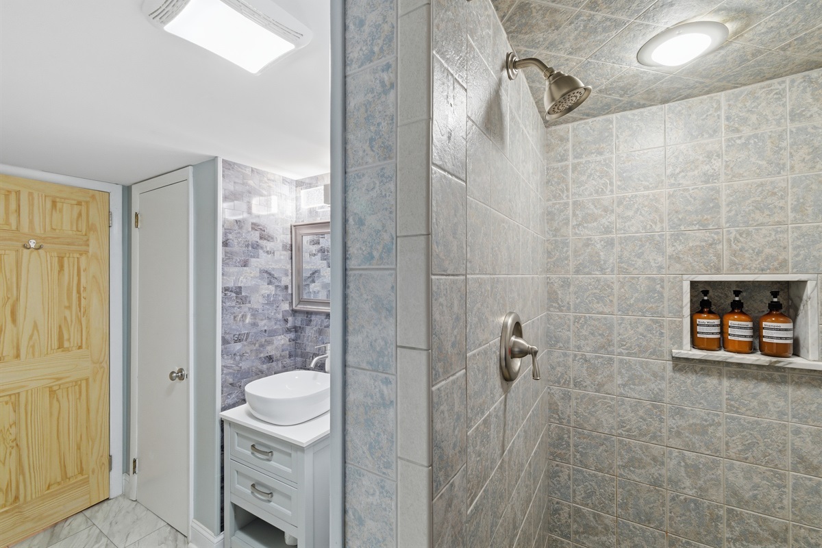 Downstairs bathroom with a stand-up shower and included shower toiletries