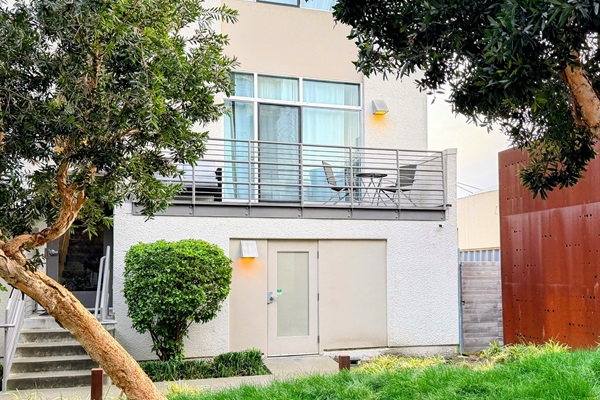 Front of unit daytime with garage entry