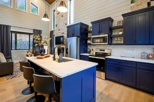 Bright, modern kitchen with bold cabinetry and ample seating