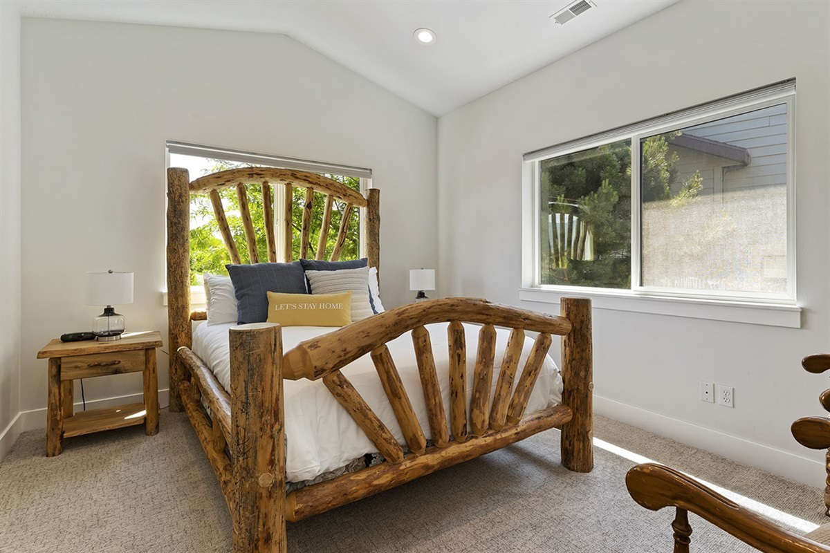 This inviting bedroom pairs rustic charm with upscale comfort, offering a plush queen bed and a warm, serene ambiance.