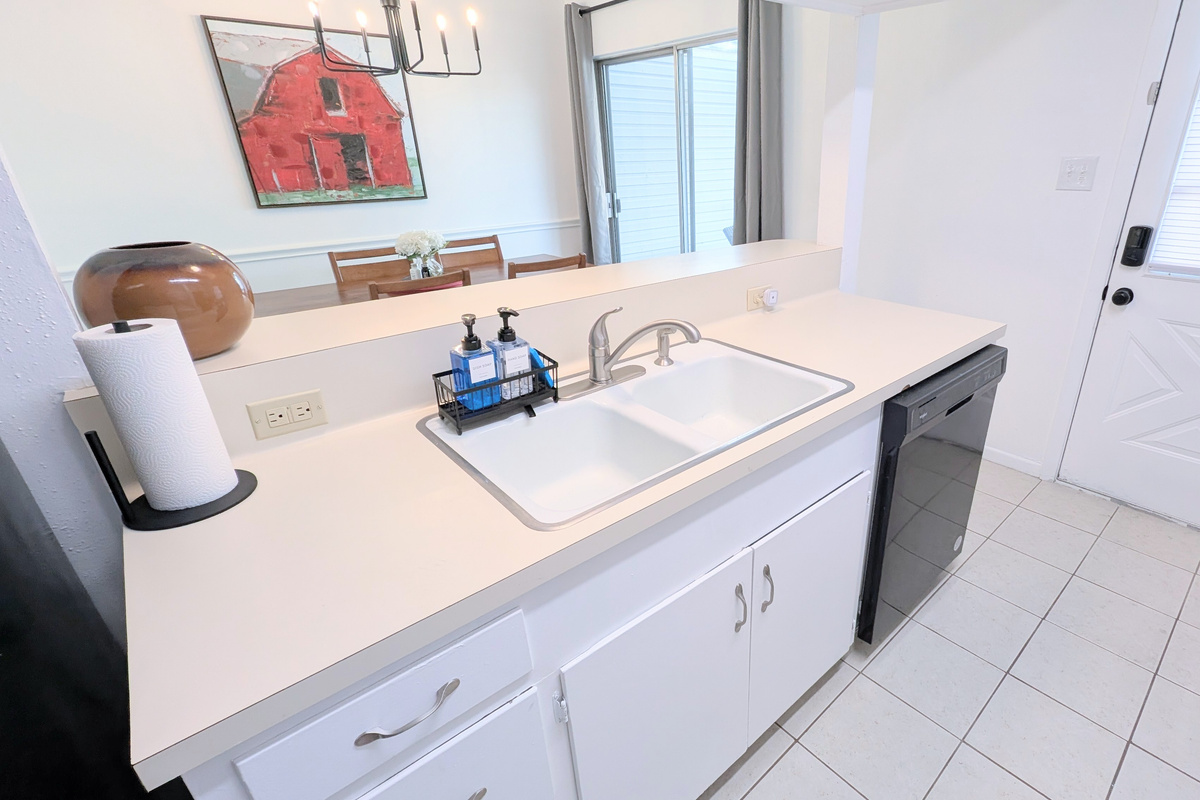Kitchen has a deep double sink and dishwasher. 