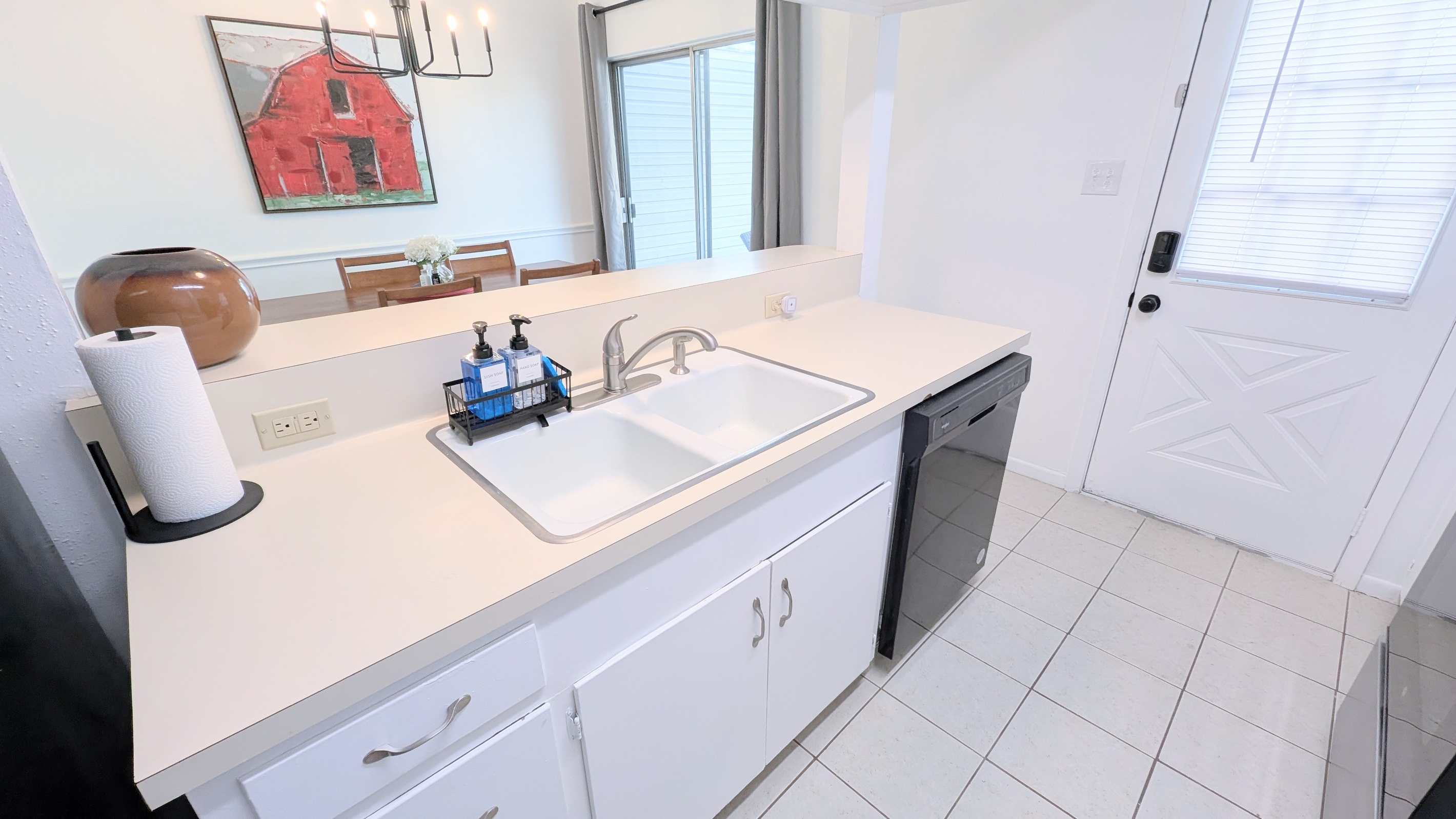 Kitchen has a deep double sink and dishwasher. 