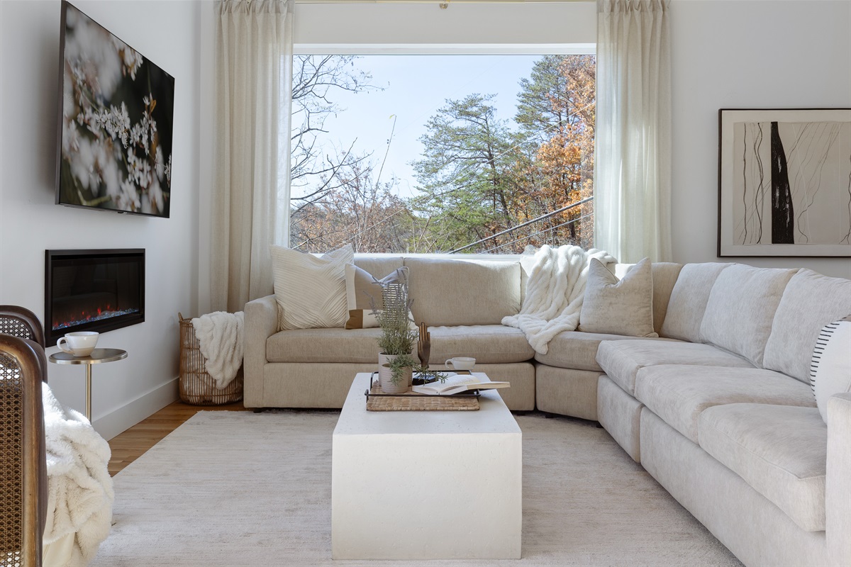 {Living Room - Gallery House} Curl up by the fire and take in the treetop views—comfort comes naturally at Gallery House