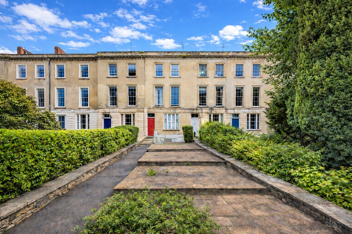 The elegant Georgian façade of our 1841 Clifton townhouse, tucked away in a quiet green setting just steps from the cafés, restaurants, and cinema of Whiteladies Road.
