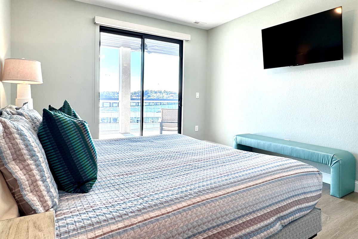 Primary King Bedroom, with balcony access, TV, and facing the Lake