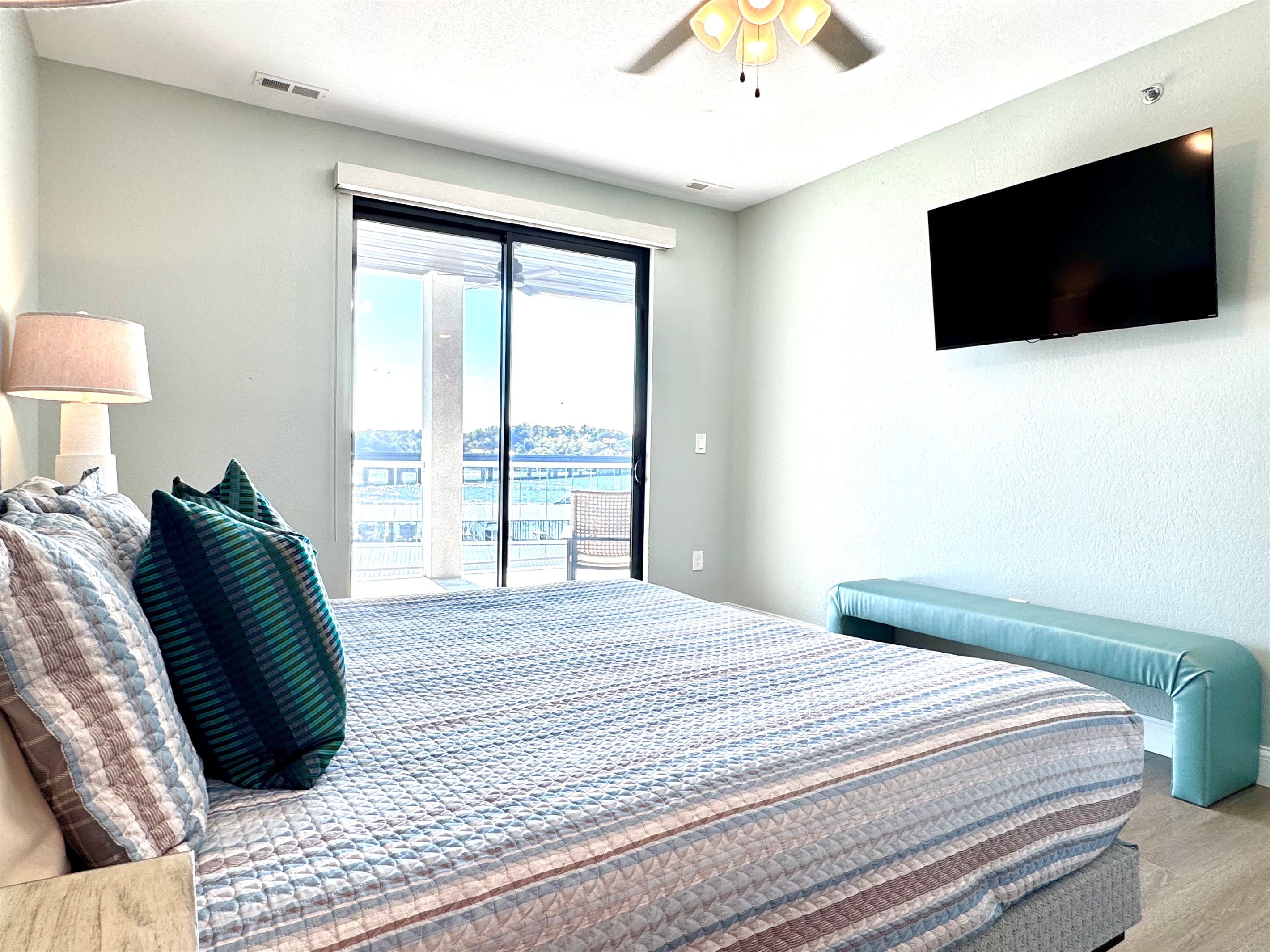 Primary King Bedroom, with balcony access, TV, and facing the Lake