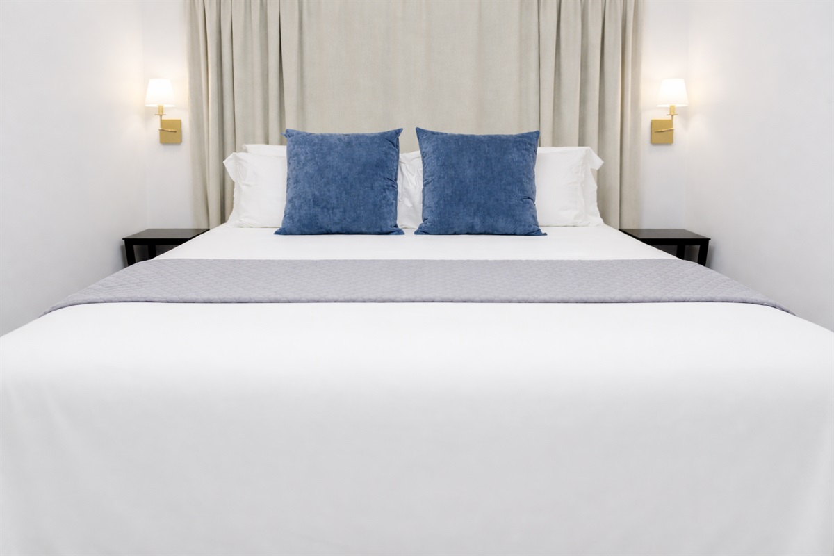 Cozy bed with plush pillows & layered linens