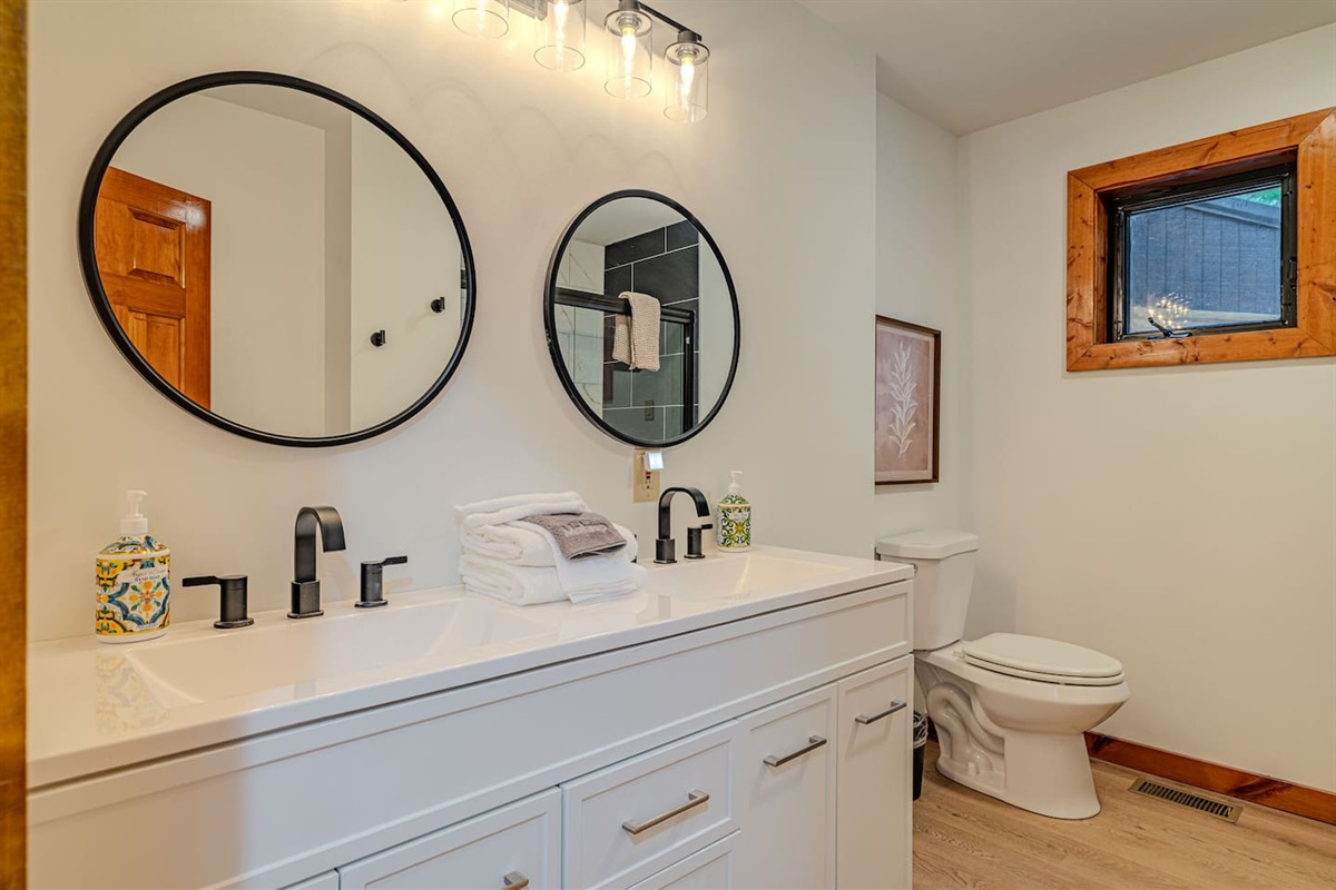 The spacious primary bath features dual vanities and an expansive walk-in shower, creating a bright, spa-inspired retreat.