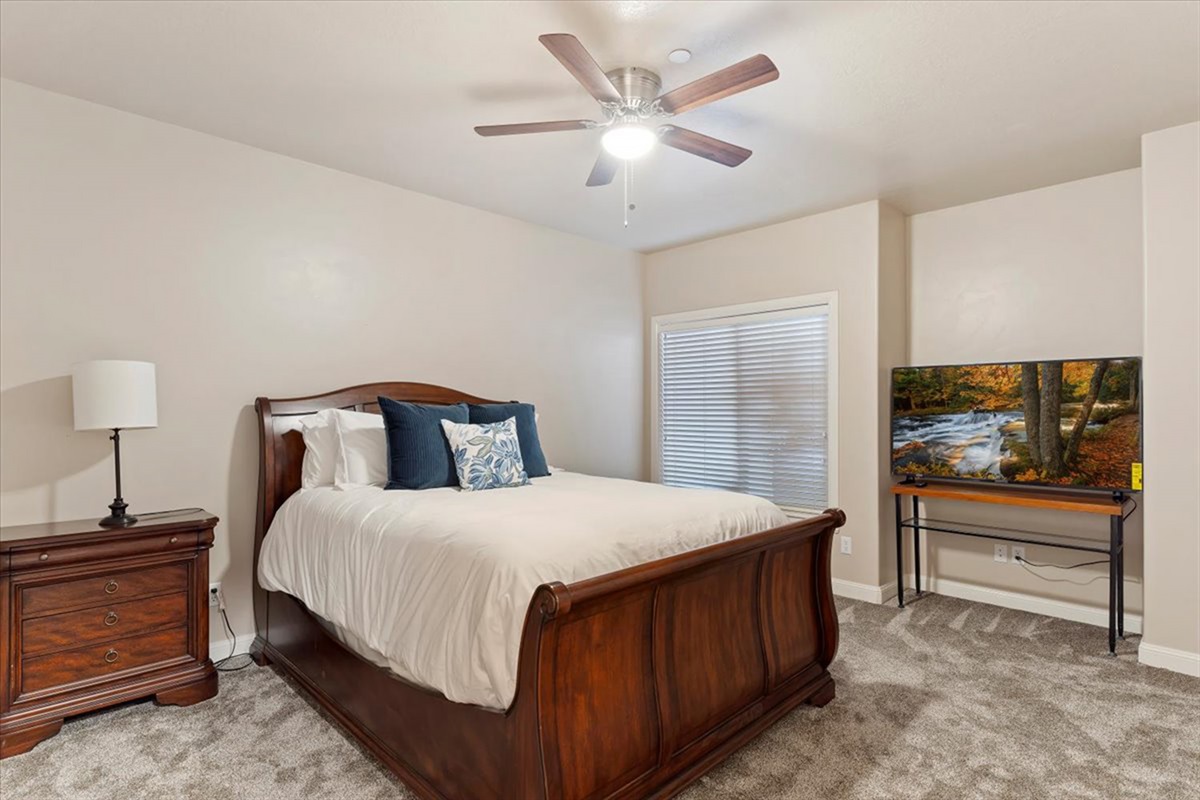 A cozy bedroom with a queen bed, soft lighting, and a calm atmosphere—ideal for restful nights after a day outdoors.