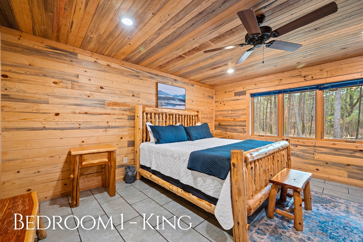 Featuring a king bed and cozy cabin details, this bedroom provides a quiet place to rest and recharge after a full day.