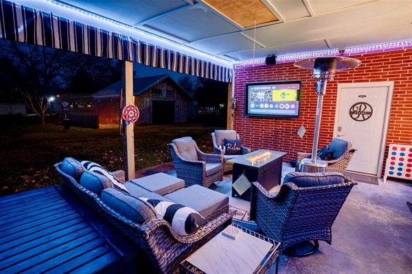 Enjoy a covered outdoor lounge with comfy seating, LED lighting, a fire table, patio heater, and a 65” outdoor TV. Perfect for relaxing, watching games, or spending time together year-round.