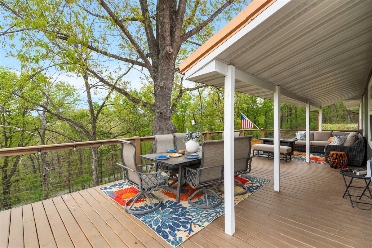 Outdoor dining deck surrounded by nature's beauty.