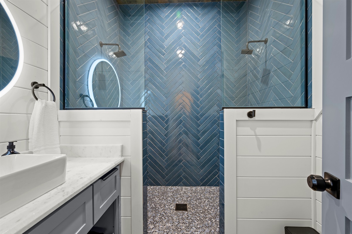 Beautiful tile accents and a bright vanity area give this bathroom a fresh, polished feel that blends comfort with style.