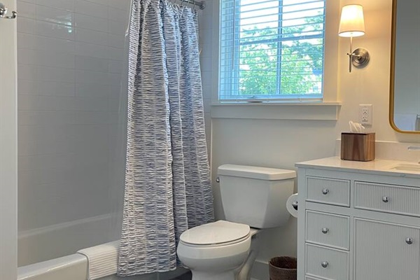 Thoughtfully updated bathroom with fresh towels and essentials.