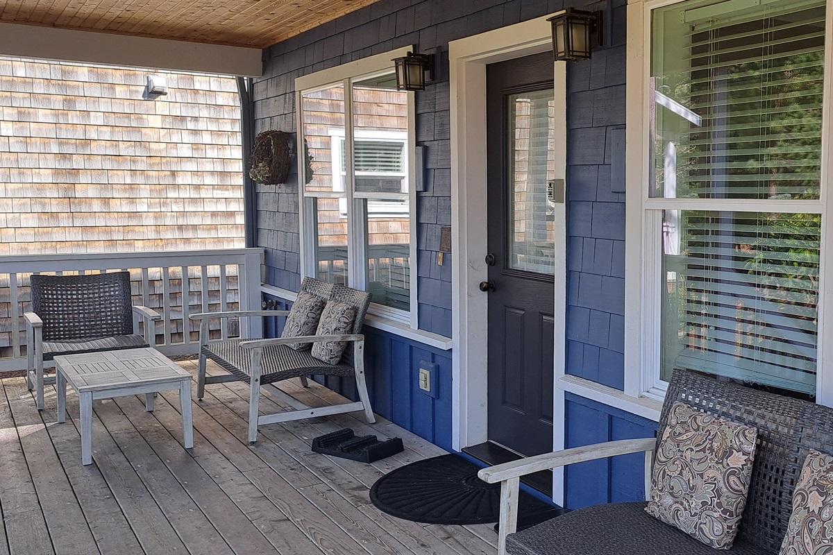Relax on the covered front porch, complete with plenty of seating for enjoying fresh coastal air.