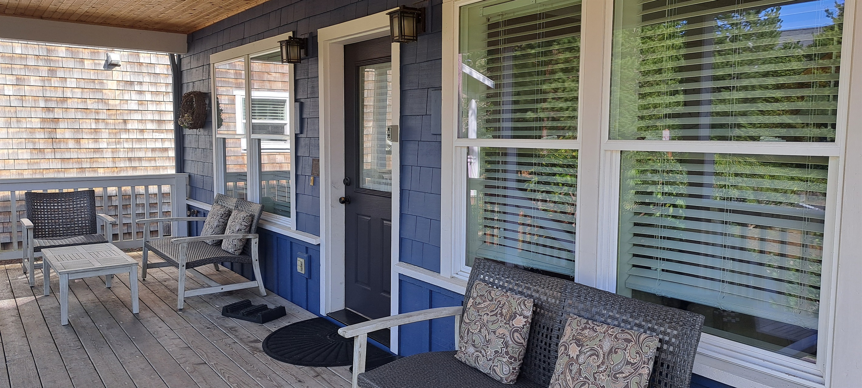 Relax on the covered front porch, complete with plenty of seating for enjoying fresh coastal air.