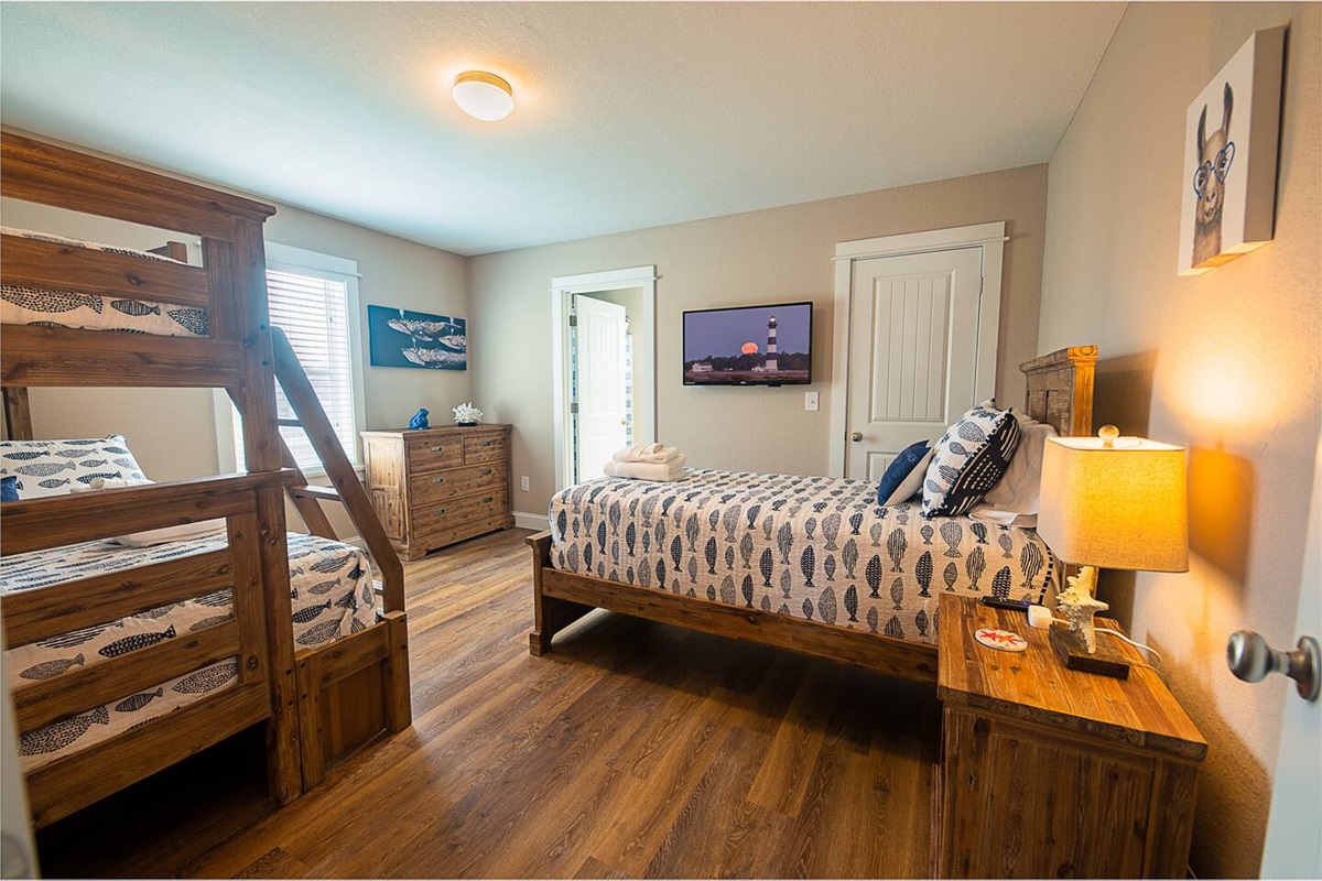 On the second floor, this spacious bunkbed room has a twin over full and additional twin bed...