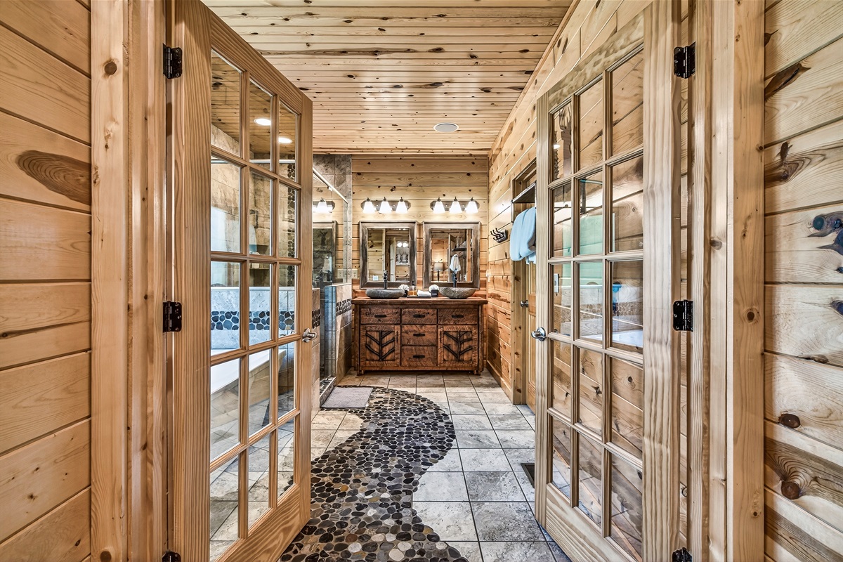 Luxurious master bath with a walk in shower, dual sinks, soaking tub for relaxation and an ensuite bathroom & frech doors for a peacful soak in the tub