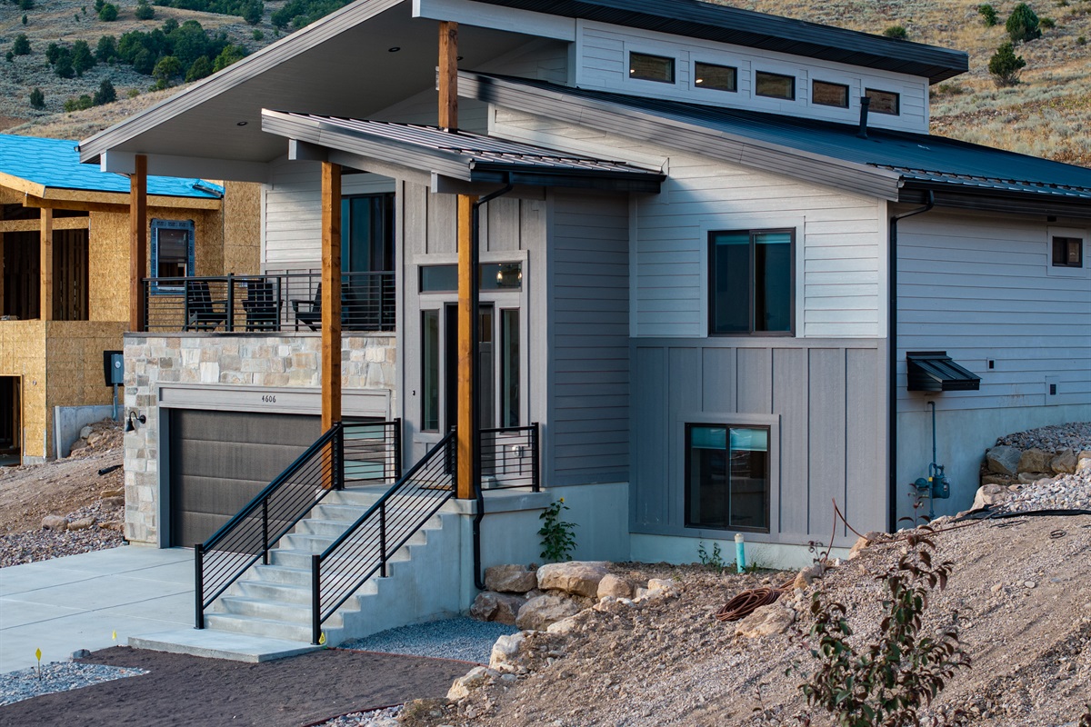 Front view of the modern multi-level home with varying rooflines, and featuring a spacious two-car garage.
