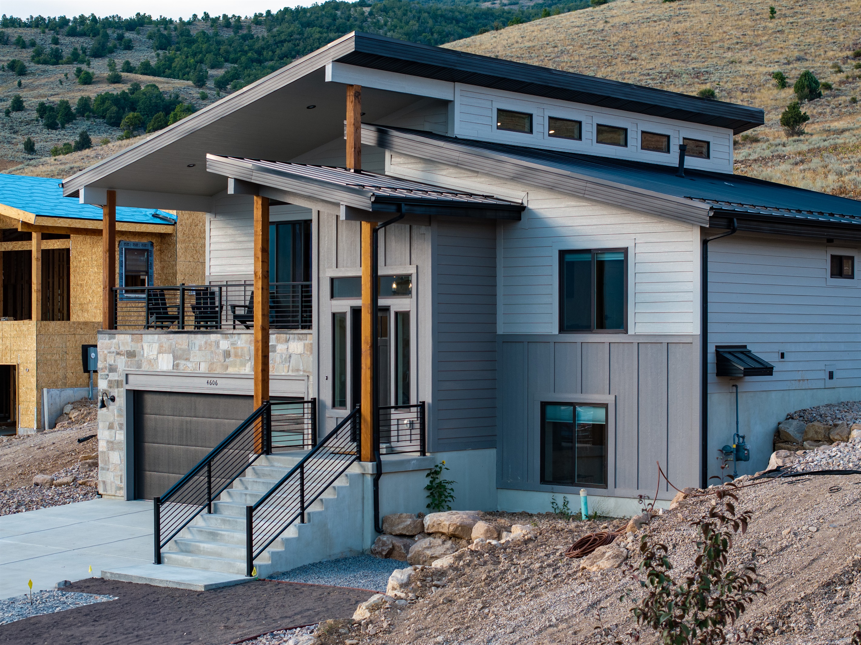 Front view of the modern multi-level home with varying rooflines, and featuring a spacious two-car garage.