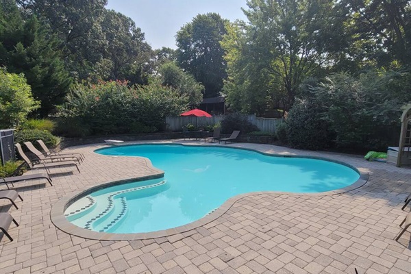 Pool in back yard (it is 39K gallons of water, 8.5 feet deep at the diving board, 3ft deep at shallow end)
